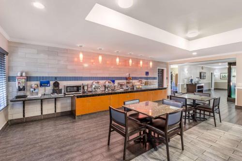 a kitchen with a table and chairs in a room at Best Western Airport Inn & Suites in Charleston