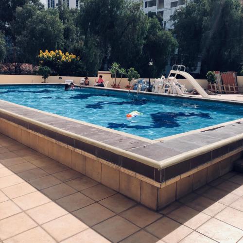 a swimming pool with a child in the water at Elite Apartment in Cochabamba