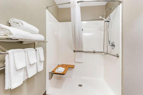 a bathroom with a shower and white towels at Best Western Airport Inn & Suites in Charleston