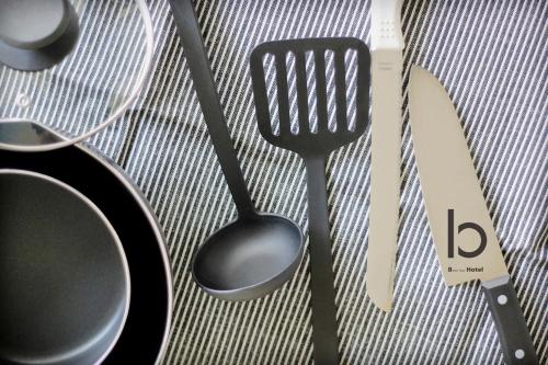 a group of utensils sitting on top of a table at b hotel Heiwaodori 701 - Spacious Apt Famous Hiroshima Dori 6ppl in Hiroshima