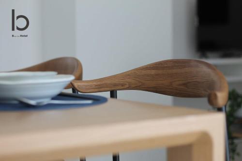 two wooden chairs sitting on top of a table at b hotel Heiwaodori 701 - Spacious Apt Famous Hiroshima Dori 6ppl in Hiroshima