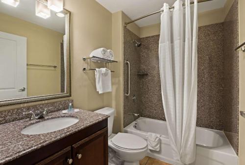 a bathroom with a sink and a toilet and a shower at MainStay Suites Houma in Houma