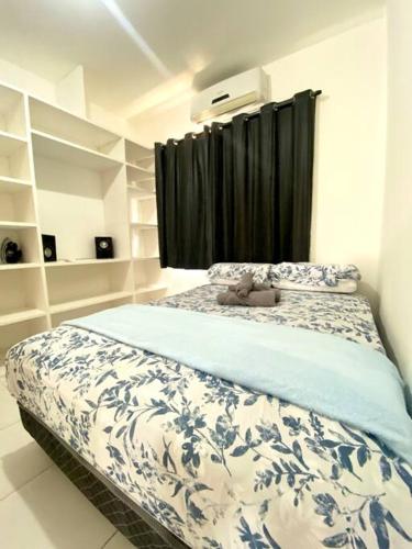 a bedroom with a bed with a teddy bear on it at Casa no Litoral Norte de Natal in Extremóz
