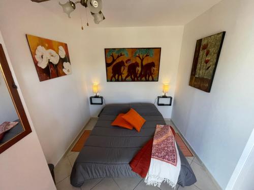a small bed in a room with two lamps at Camere Aeroporto Cagliari Elmas in Elmas