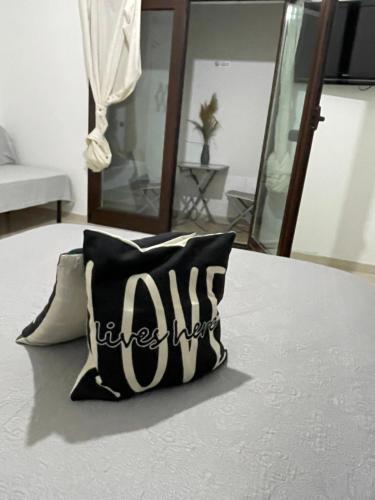 a black and white pillow sitting on a table at Camere Aeroporto Cagliari Elmas in Elmas