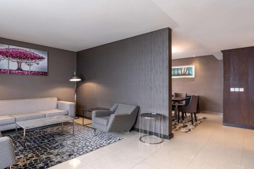 a living room with a couch and a table at Radisson Blu Okoume Palace Hotel, Libreville in Libreville