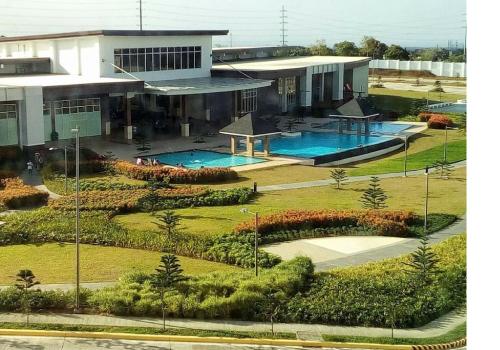 an aerial view of a building with two swimming pools at Blowing In The Wind in Tagaytay