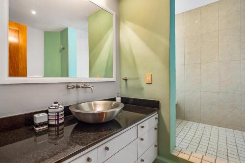 a bathroom with a bowl sink and a shower at Villa by the Sea in Puerto Vallarta