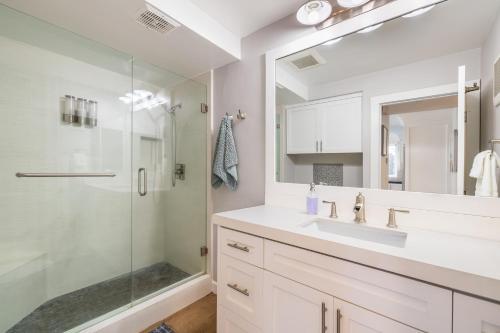 a bathroom with a sink and a shower at Ocean Breeze I by AvantStay Steps to the Beach in Newport Beach