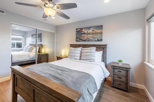 a bedroom with a bed and a ceiling fan at Ocean Breeze I by AvantStay Steps to the Beach in Newport Beach