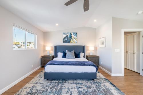a bedroom with a blue bed and two night stands at Ocean Breeze II by AvantStay Steps to the Beach in Newport Beach