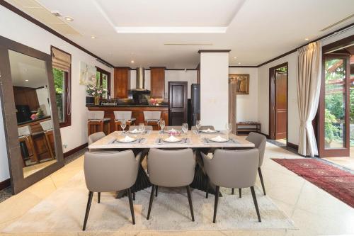 a dining room with a table and chairs at Saitaan Villa Dennapa Bang Tao Beach in Bang Tao Beach