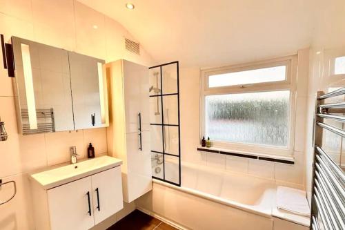 a bathroom with a sink and a window at Wembley wow house in Preston