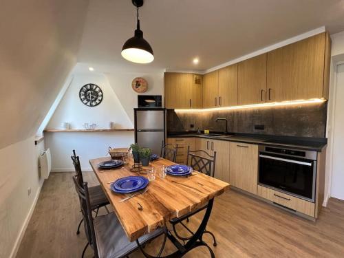 une cuisine avec une table en bois et des chaises ainsi qu'une salle à manger dans l'établissement Le Meaux Sacré Vue Cathédrale Hyper Centre Gare Disney, à Meaux