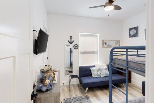 a bedroom with a bunk bed and a blue chair at Carmel Cottage in Foley