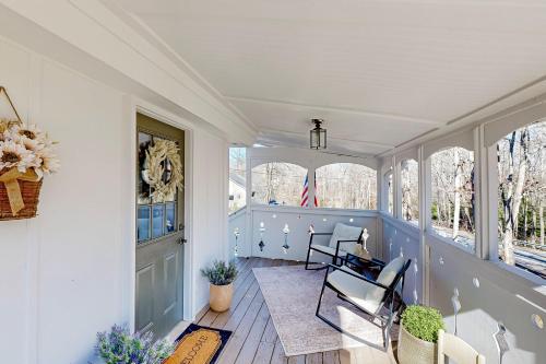 a room with two chairs and a porch with windows at The Lakeway House in Buford