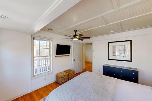 a bedroom with a bed and a ceiling fan at The Lakeway House in Buford