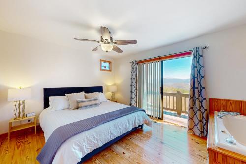 a bedroom with a bed and a tub and a window at Skyridge in Blairsville