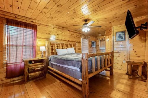 1 dormitorio con 1 cama en una cabaña de madera en Endless Joy, en Sevierville