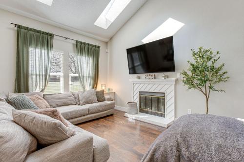 a living room with a couch and a fireplace at 6 Mi to Dtwn Arvada Home with Hot Tub and Yard in Arvada