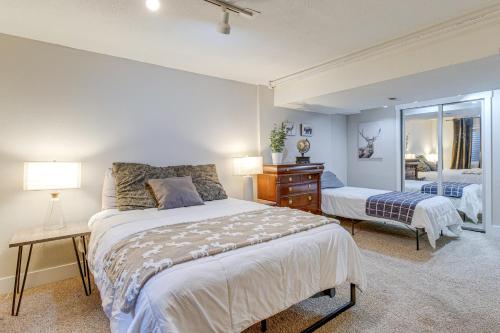 a bedroom with a bed and a dresser and a mirror at 6 Mi to Dtwn Arvada Home with Hot Tub and Yard in Arvada