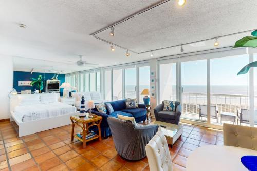 a bedroom with a bed and a living room at Galvestonian 710 in Galveston