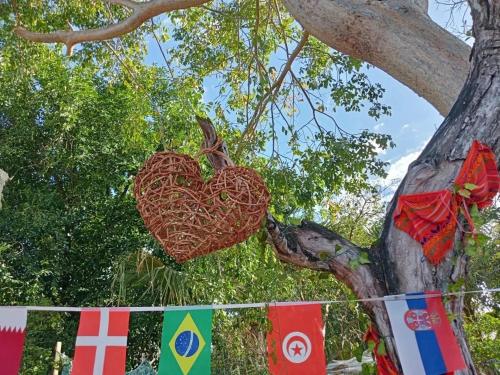 a heart hanging on a tree next to flags at Hostal Republic in Mérida