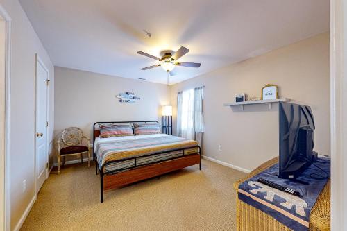 a bedroom with a bed and a flat screen tv at The Palms --- 36507 Palm Dr #2102 in Rehoboth Beach