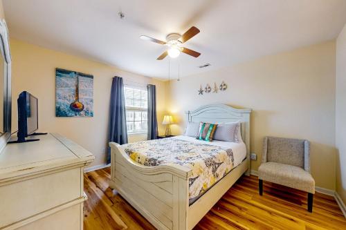 a bedroom with a bed and a chair at The Palms --- 36507 Palm Dr #2203 in Rehoboth Beach