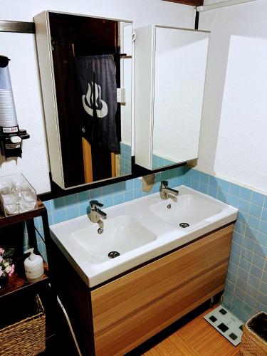 a bathroom with a sink and a mirror at さいの郷「椛」 in Kagamino