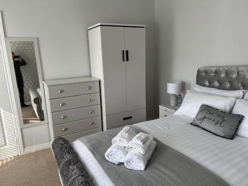 a bedroom with a bed and a dresser and a mirror at Fair Green B&B in Ballygawley