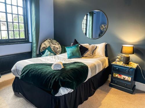 a bedroom with a bed with a mirror on the wall at Spacious House with 4 parking spaces in Canterbury