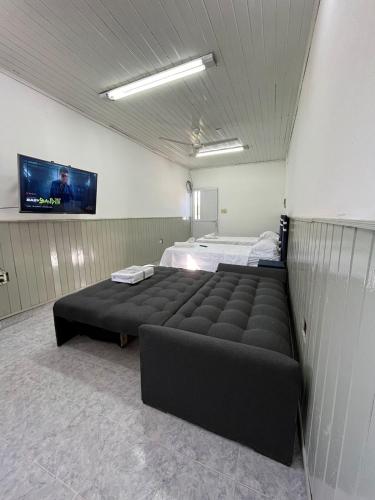 a bedroom with two beds and a flat screen tv at DEPARTAMENTOS A METROS DE LA UNAF in Formosa