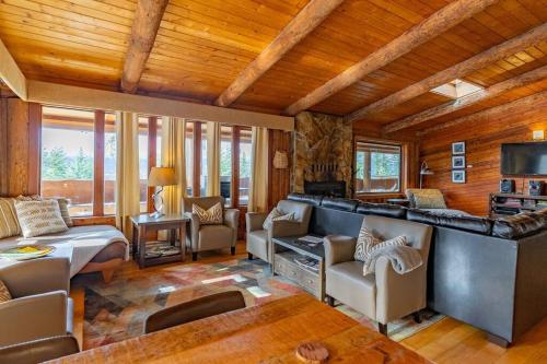 a living room with a couch and a tv at New Denver Lodge in New Denver