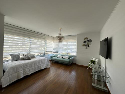 a large bedroom with a bed and a couch at Departamento en Puerto Madero in Buenos Aires