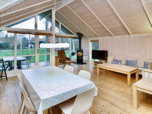a living room with a table and a couch at 6 person holiday home in Højby-By Traum in Højby
