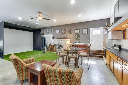 a living room with a table and chairs and a kitchen at Spacious Lake of the Ozarks Escape with Deck and Views in Linn Creek