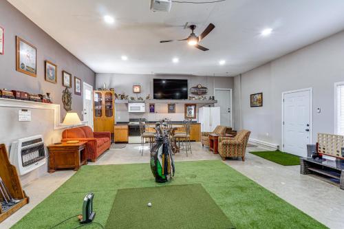 a living room with a golf ball on a putting green at Spacious Lake of the Ozarks Escape with Deck and Views in Linn Creek