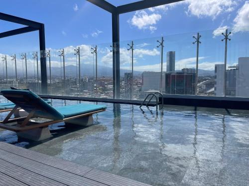 a swimming pool on top of a building with a view at SkyGarden Nunciatura Luxury Apartment in San José