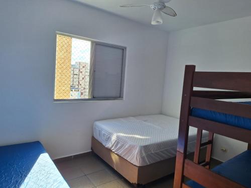 - une petite chambre avec un lit et une fenêtre dans l'établissement Nosso amor em paz, à Praia Grande