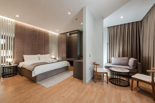 a hotel room with a bed and a couch at Troci Hotel in Tirana