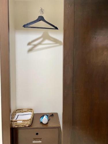 a door leading into a room with a desk and a hanger at Plaza Del Norte Hotel and Convention Center in Laoag