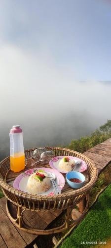 a picnic table with three plates of cake and a drink at น่านฟ้าสะปัน in Ban Huai Ti