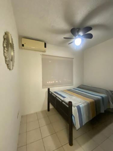 - une chambre avec un lit et un ventilateur de plafond dans l'établissement HERMOSA CASA PRIVADA EN FRACC VALLE VERDE, AL SUR DE LA CIUDAD., à Tapachula