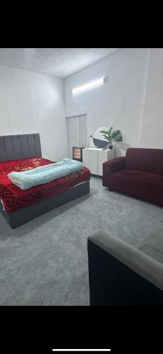 a bedroom with a bed and a couch at Furnished studio with private entrance in Irbid