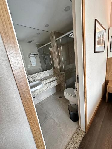 a bathroom with a toilet and a sink at Romastay Itaim SP in São Paulo