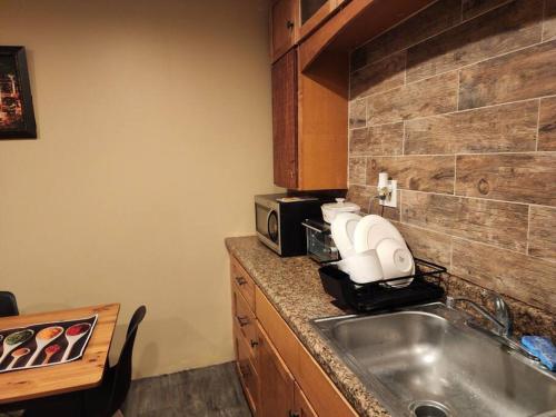 a kitchen with a sink and a microwave at spacious and indulging in Meriden