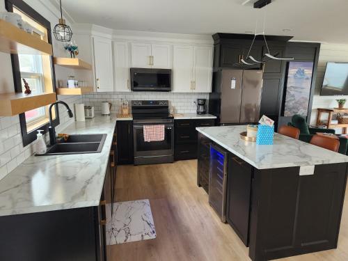 a kitchen with black and white counter tops at Seaclusion Twillingate in Twillingate