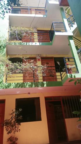ein Gebäude mit einem Balkon mit Pflanzen in der Unterkunft Hospedaje PARAISO in Ayacucho