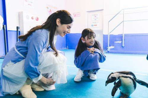 a woman and a little girl looking at a penguin at Grand Mercure Ise-shima Resort & Spa in Shima